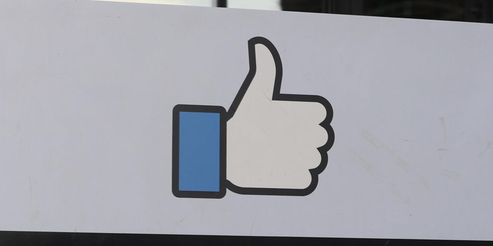 Facebook "Like" hand outside building
