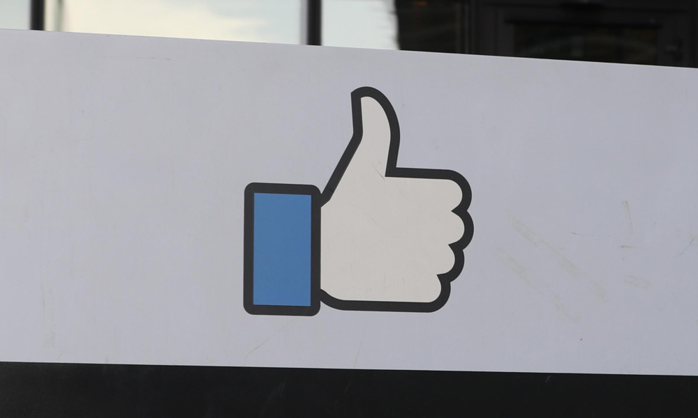 Facebook "Like" hand outside building